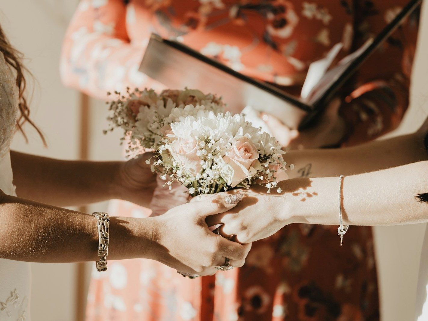person holding white flower bouquet